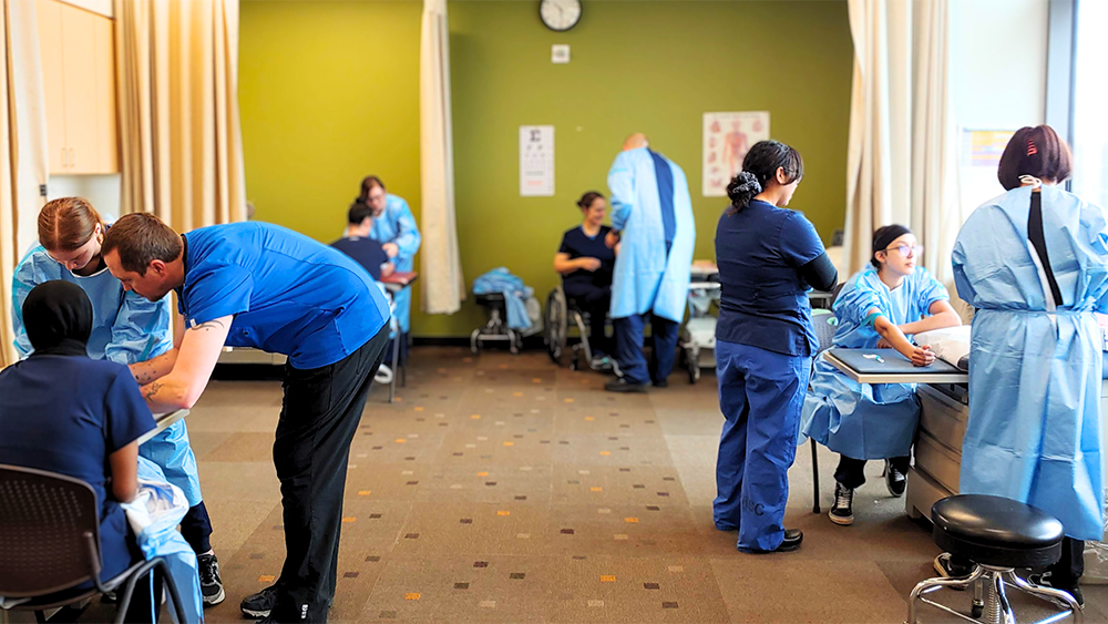 Medical Assisting students in a hospital setting practicing drawing blood