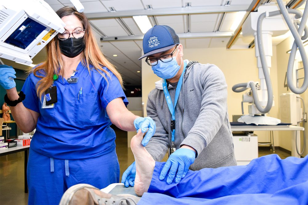 Medical Imaging student setting up a mock patient for an ankle head X-ray