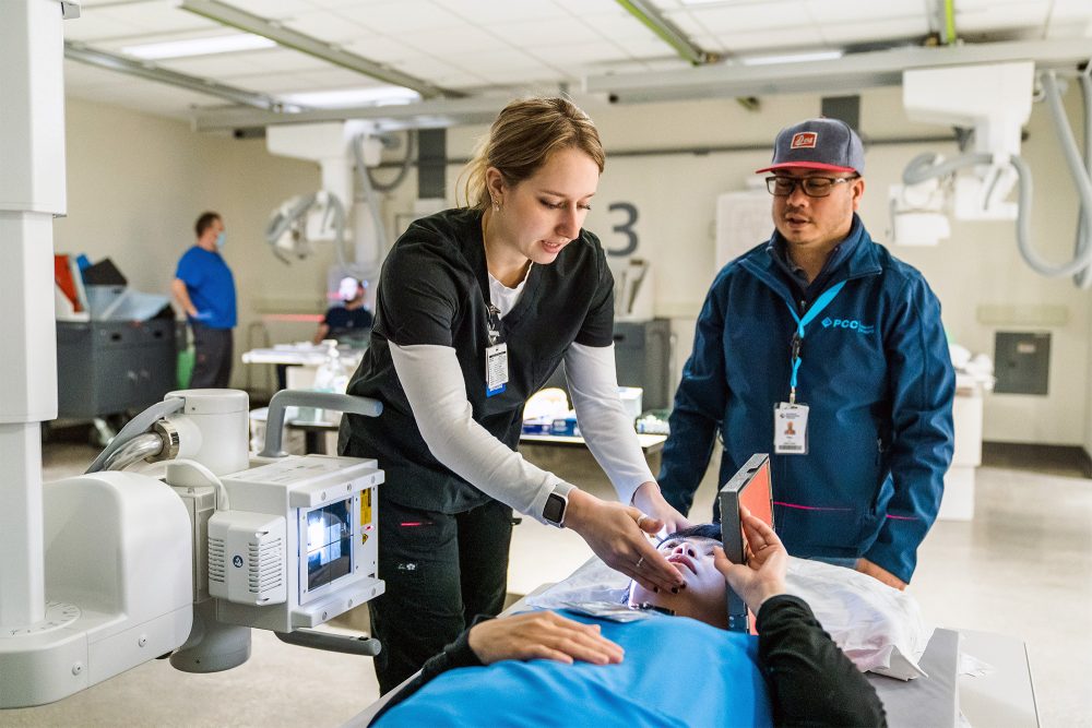 Medical Imaging student setting up a mock patient for a head X-ray