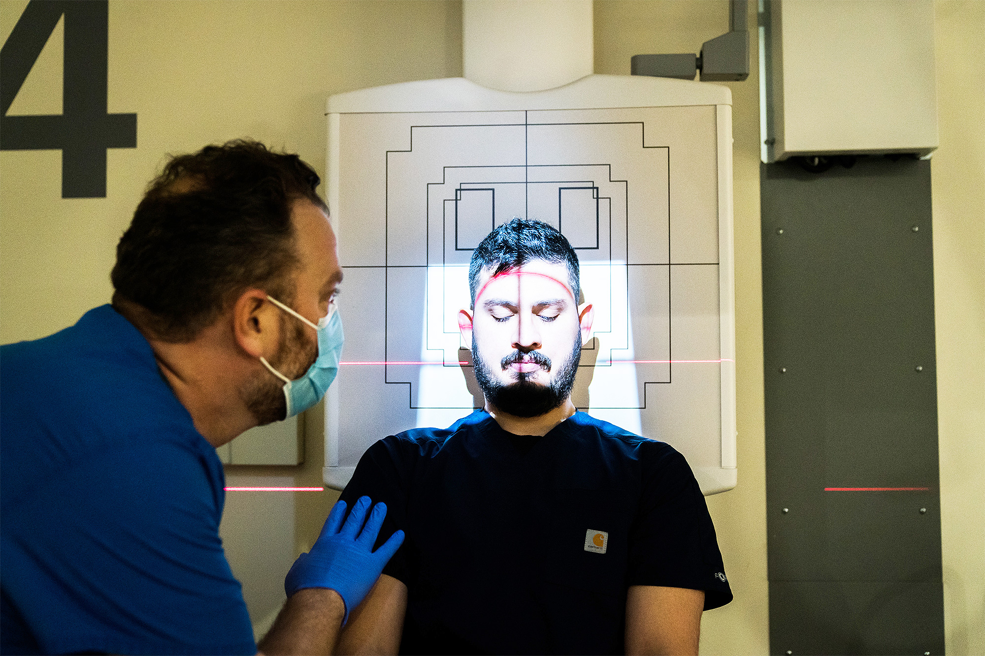 Medical Imaging student setting up a mock patient for a head X-ray from above