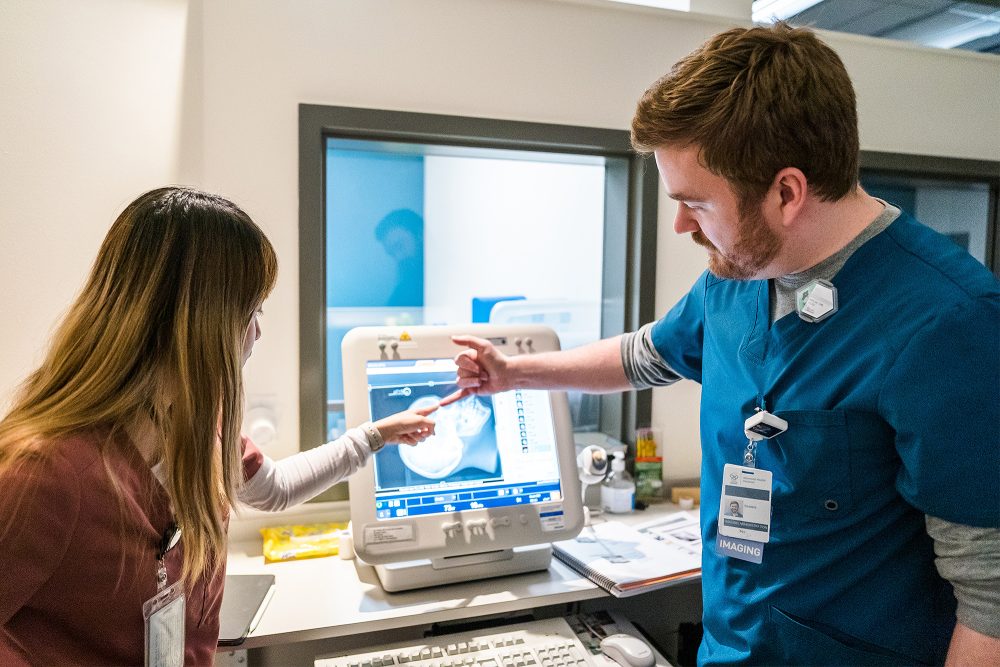 Radiography students discussing an X-ray together