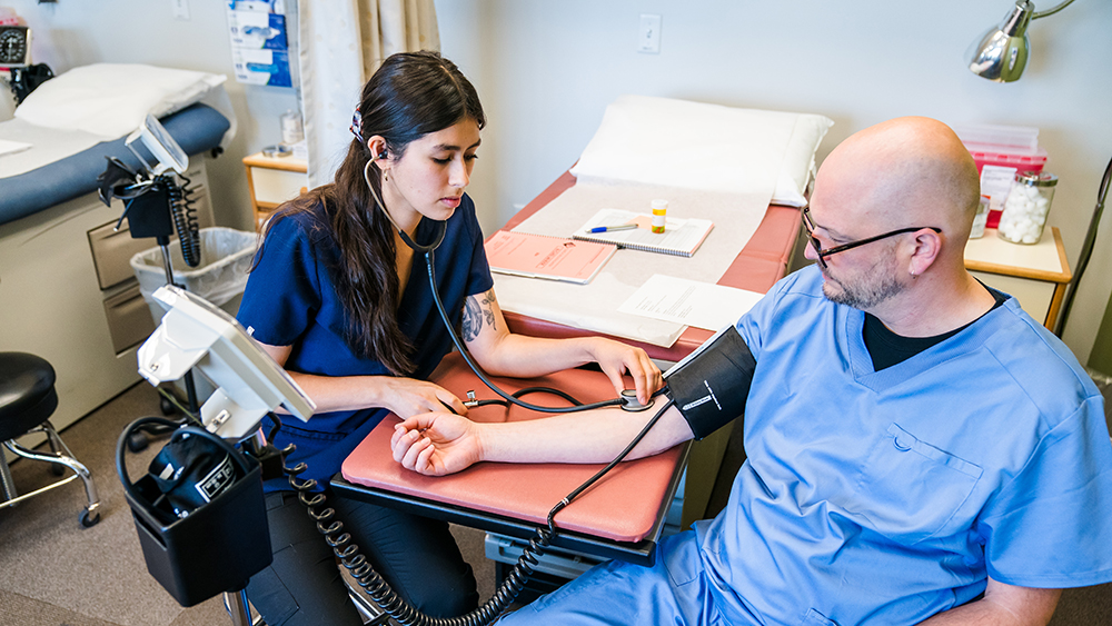 Student taking another student's blood pressure
