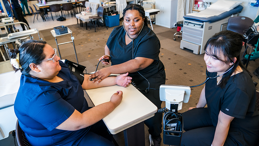 Medical students taking each other's blood pressure