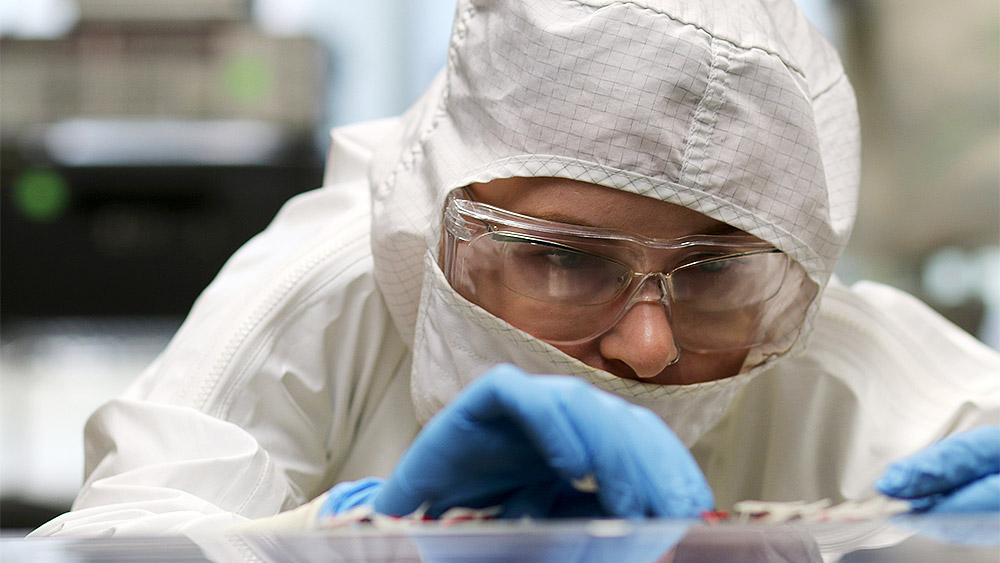 Student in a clean suit working on a project