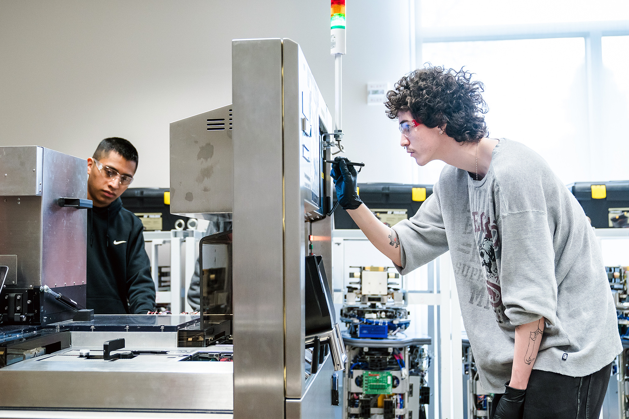 Microelectronics Technology students working with large equipment in the lab