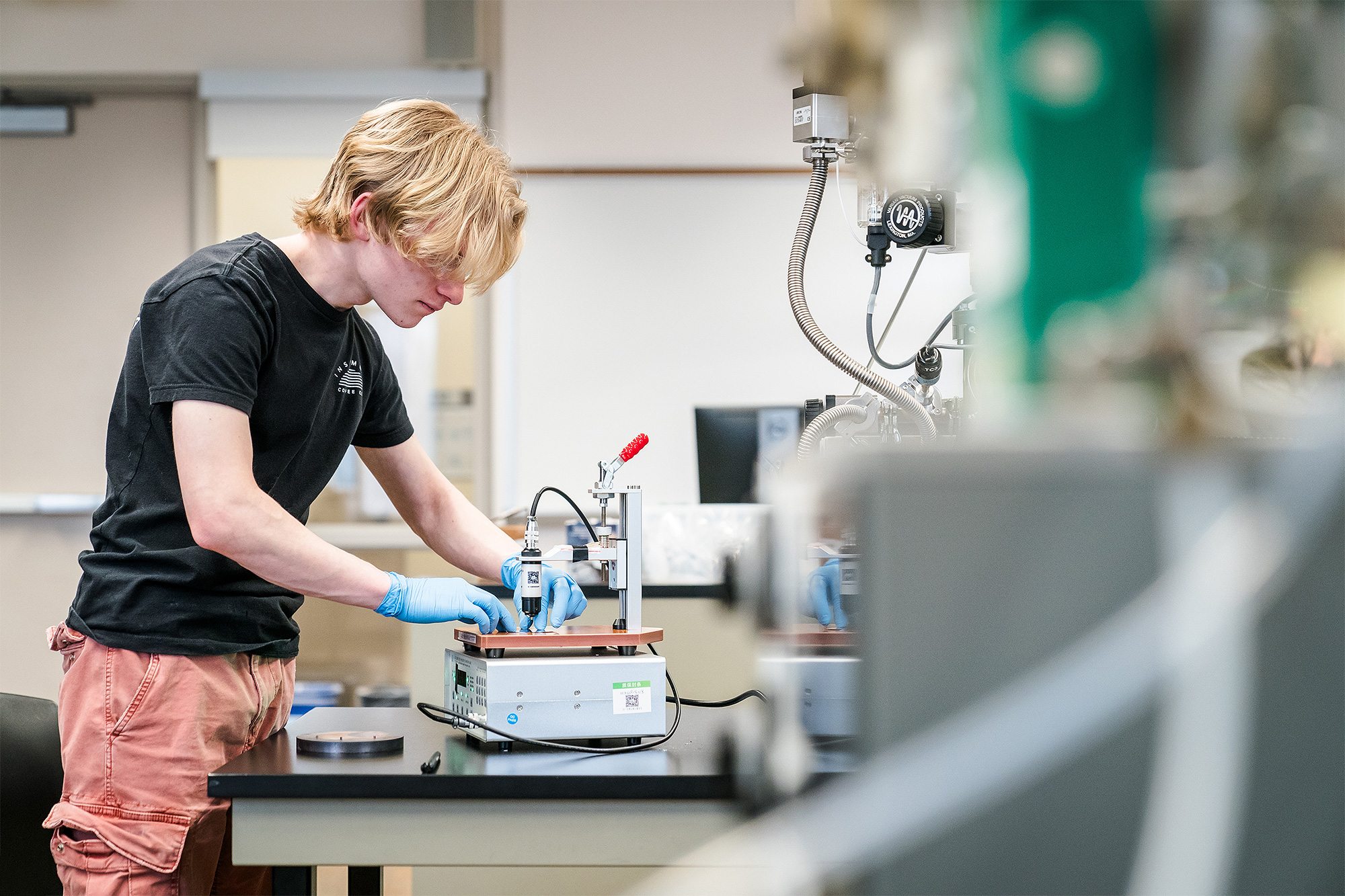 Microelectronics Technology student working with wet etch equipment in the lab