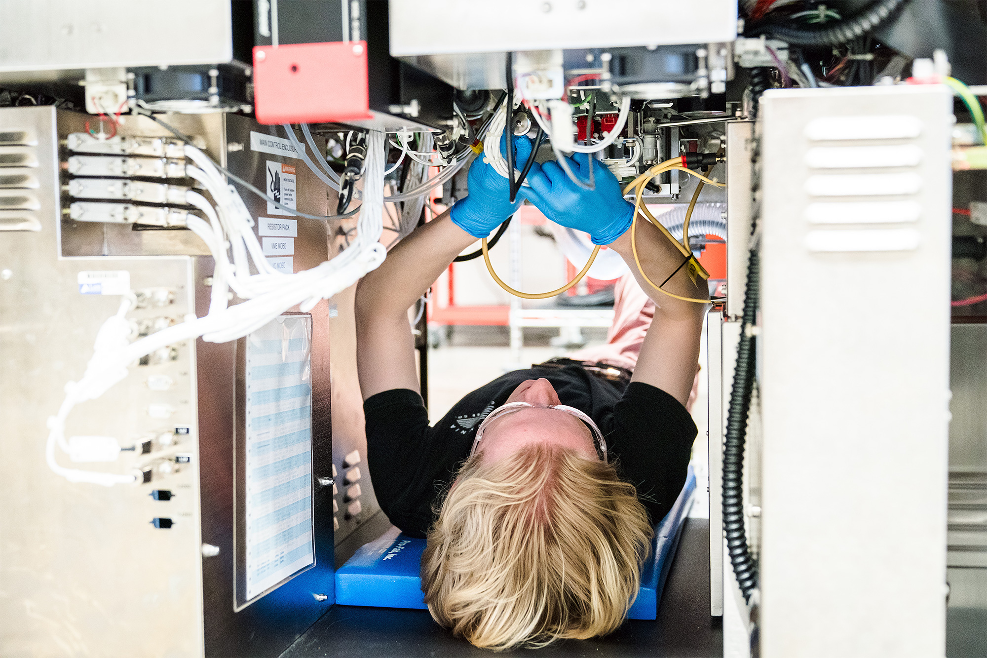 Microelectronics Technology student adjusting the wiring on solar voltaic equipment in the lab