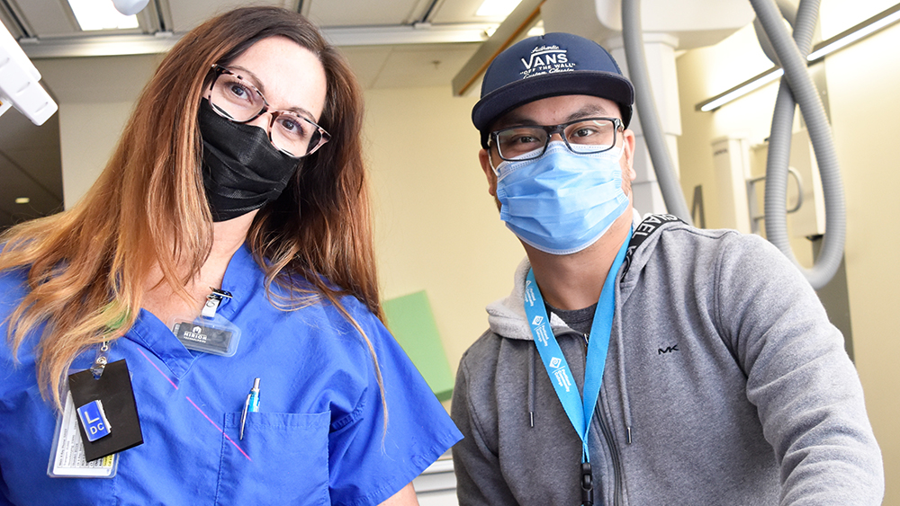 Students with masks on, looking at the camera in medical office