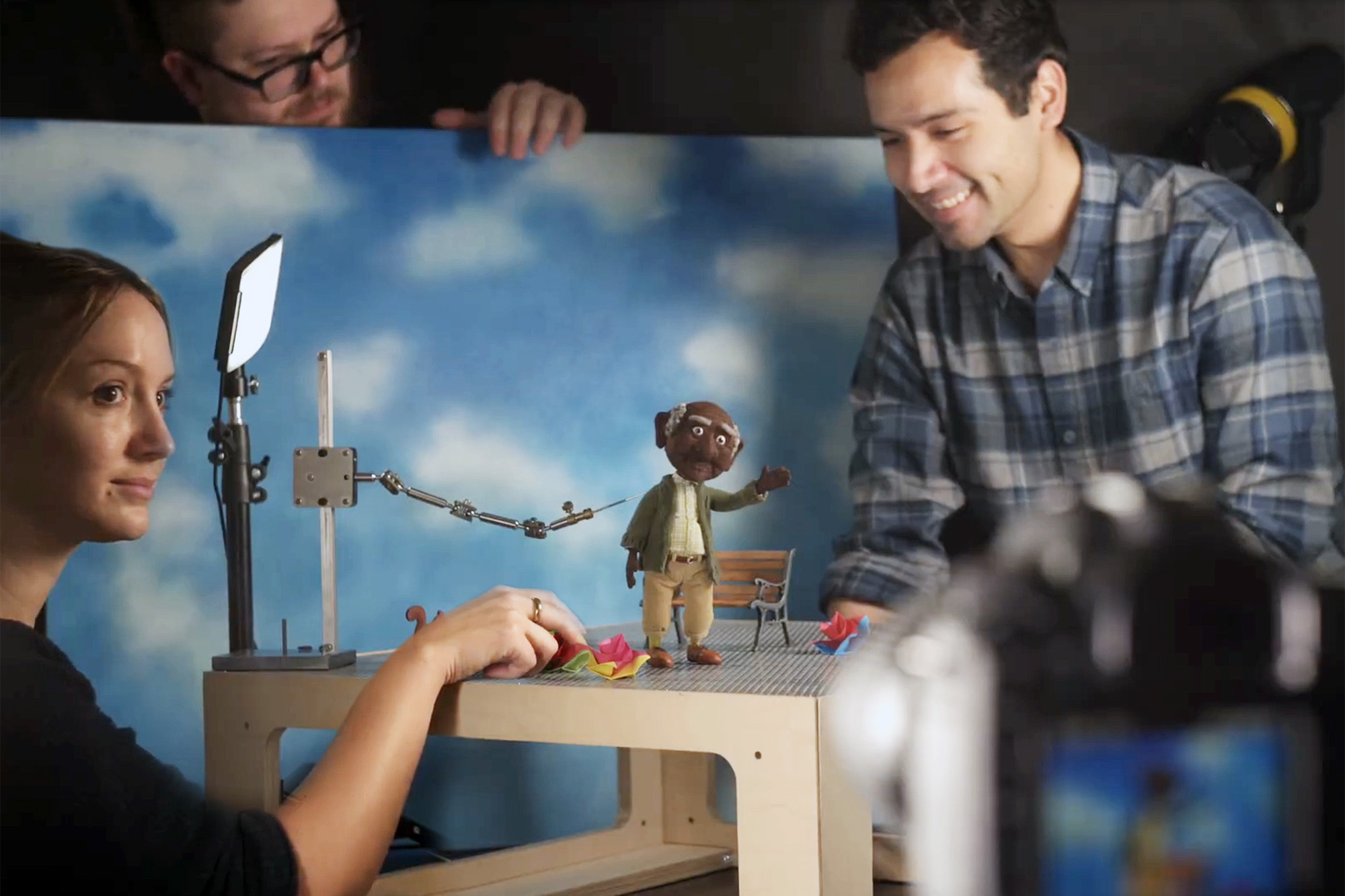 Multimedia students working with their stop motion character on its set in the studio