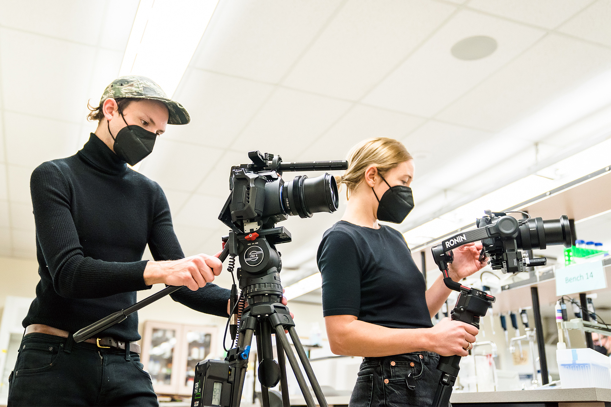 Multimedia students filming in a biotechnology lab on campus