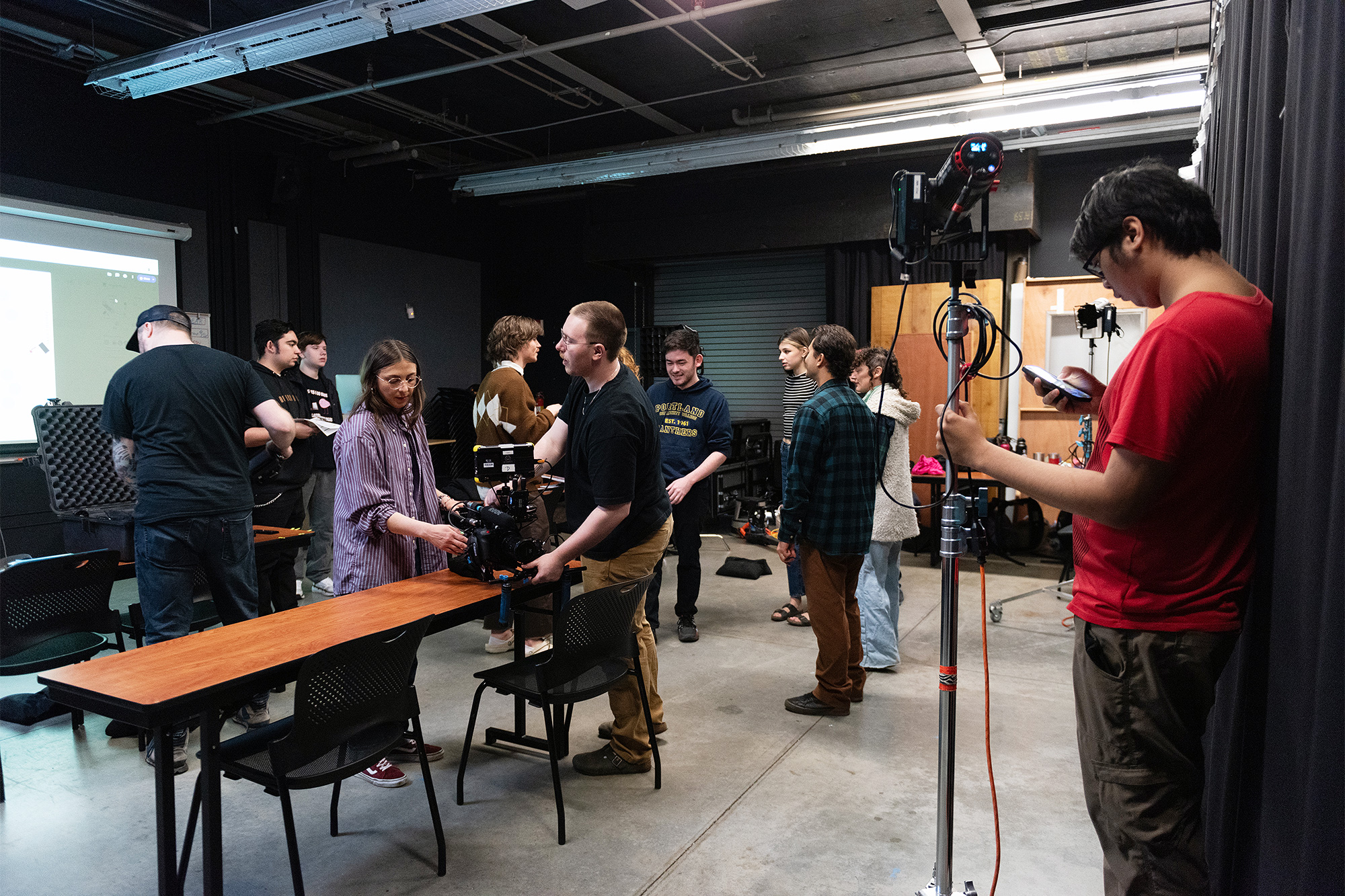 Multimedia working with film equipment in the studio