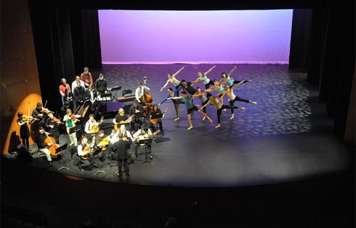 Music students playing for a group of dancers during a performance