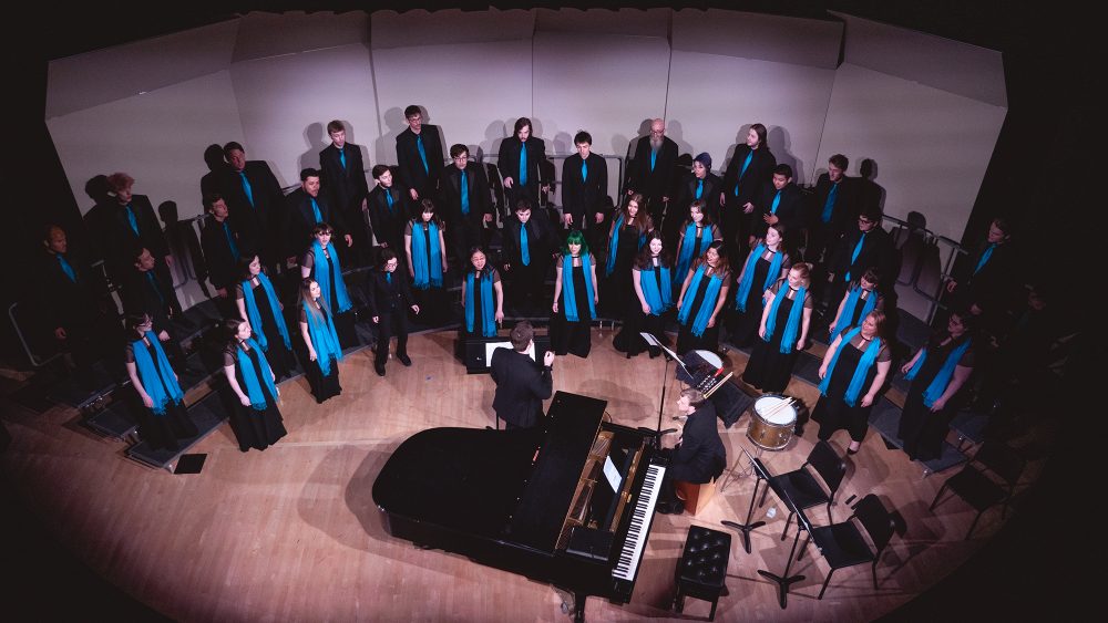 Photo from above of students singing in a choir concert