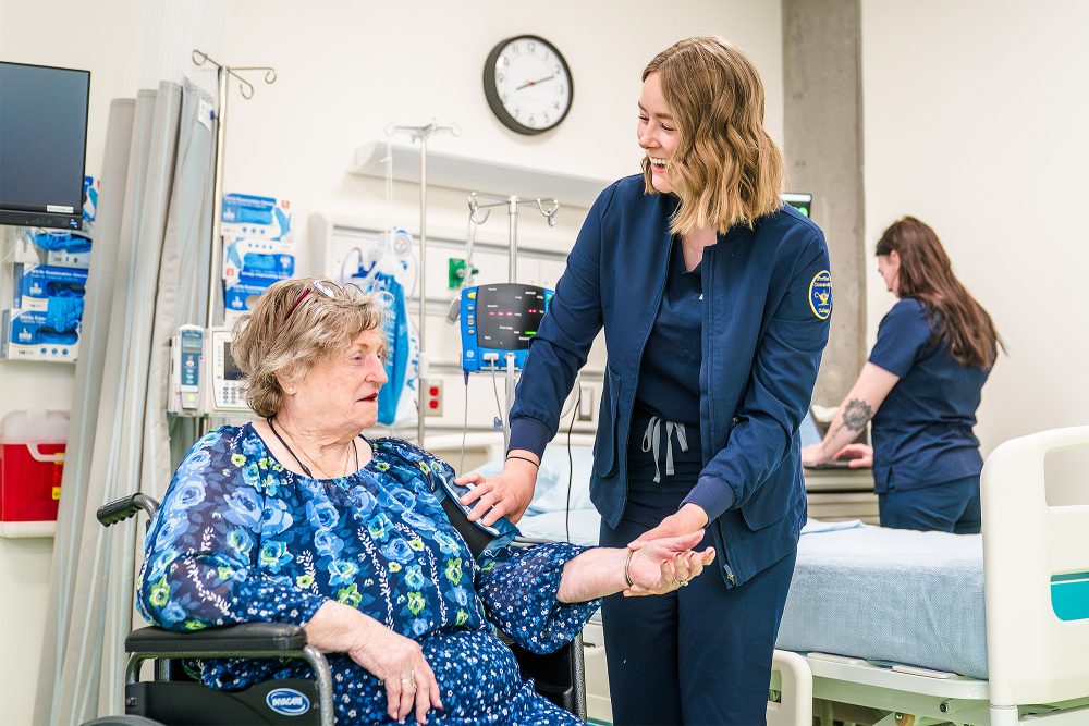 Nursing Assistant student taking a patient's blood pressure