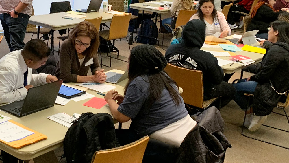 Paralegal students helping other students at a campus DACA workshop