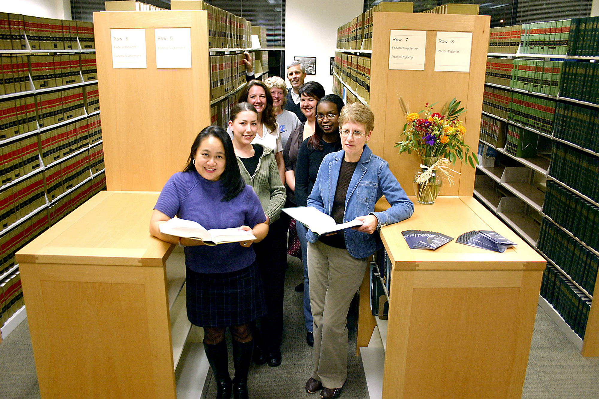 Paralegal students standing together in the paralegal library