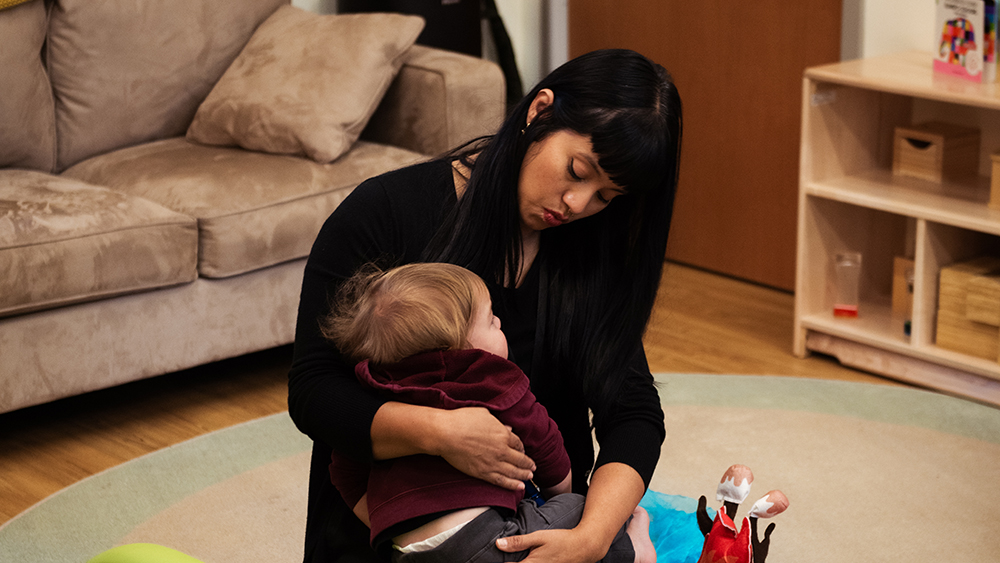 Caregiver holding a young child