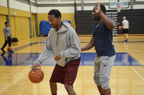 Students playing basketball in the gym