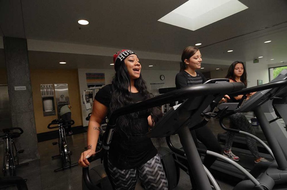 Students walking and running on treadmills in the Cascade Gym loft