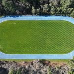 Aerial view of track around a mowed grass field