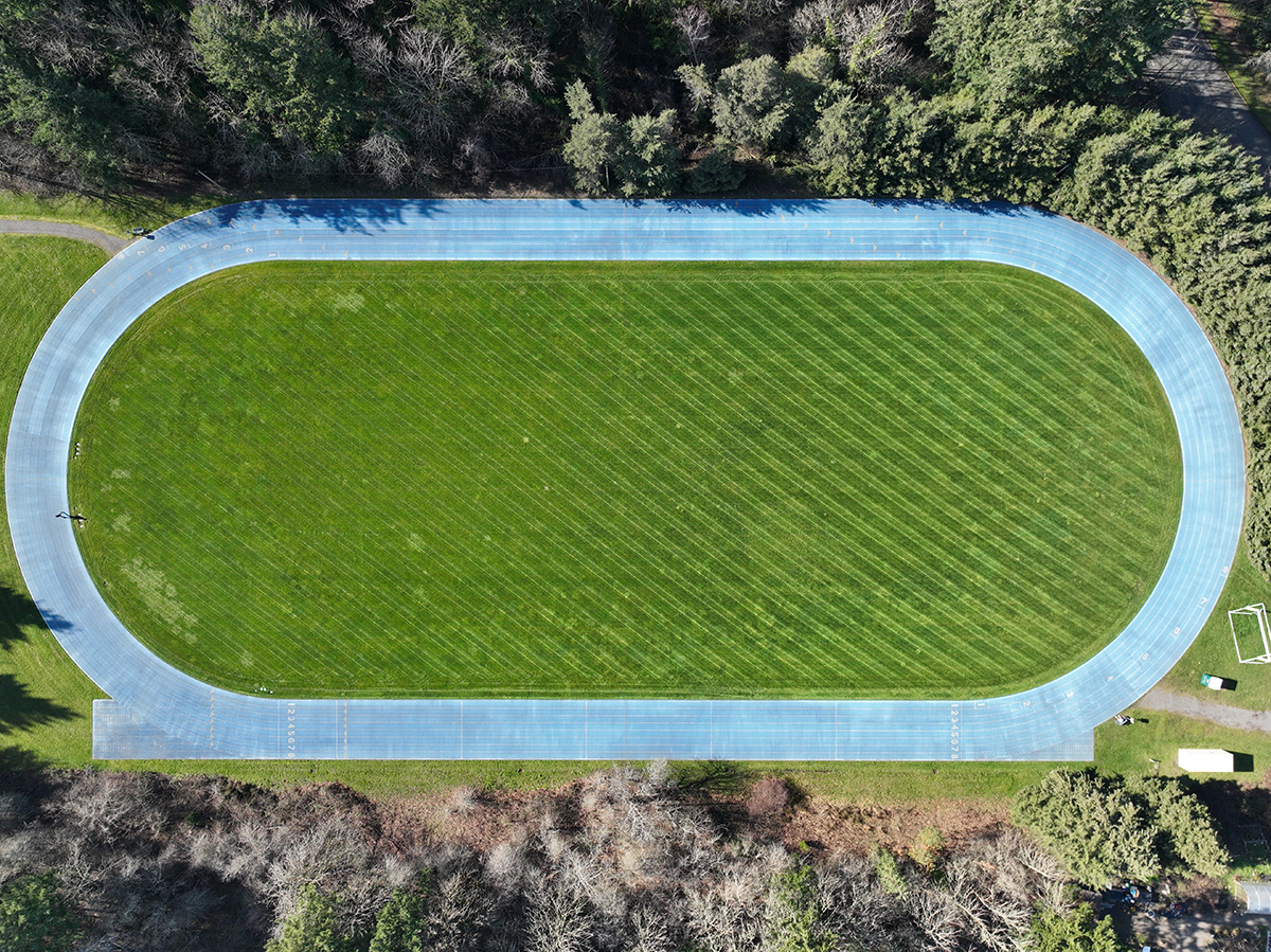 Aerial view of track around a mowed grass field