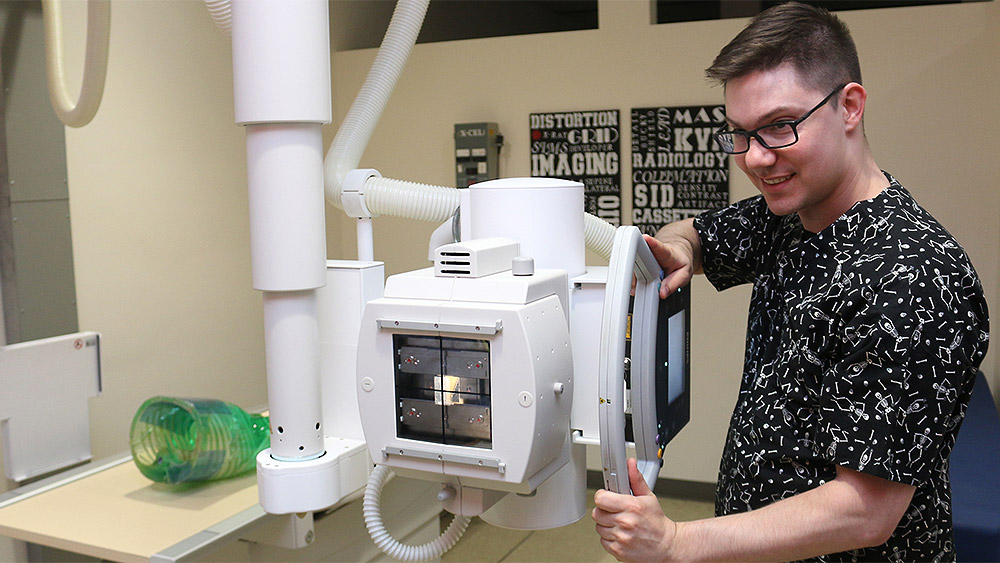Student working with an x-ray machine