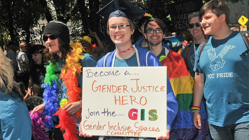 Students at the PCC Pride Parade holding a poster about gender justice