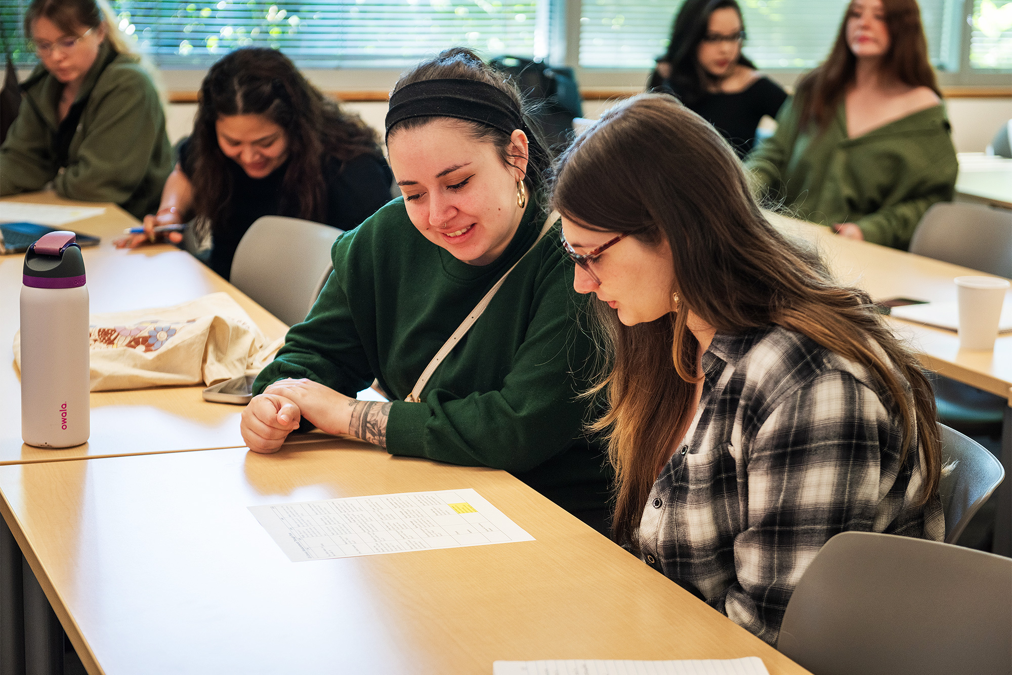 Sociology students working on a handout together in class