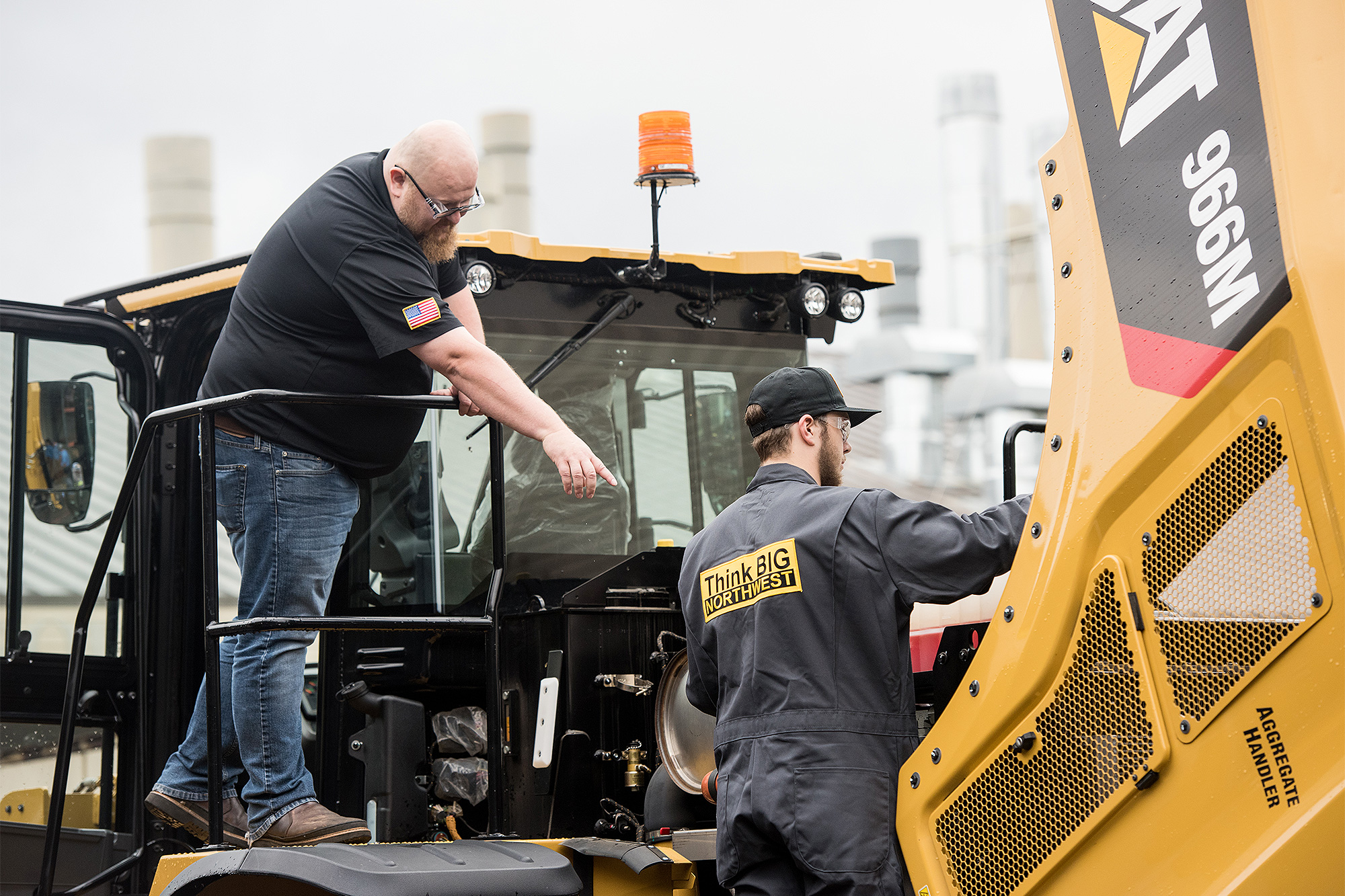 Instructor showing a ThinkBIG student how to work on a large CAT engine