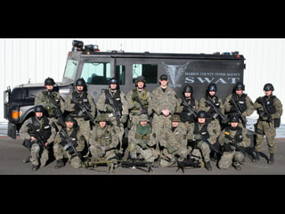 SWAT team standing in front of the truck