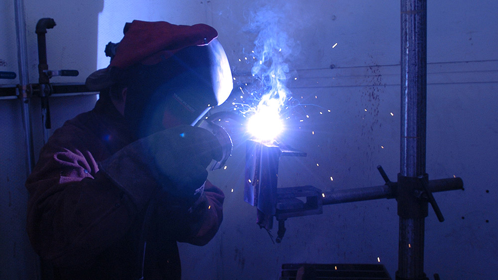 Student welding in the shop