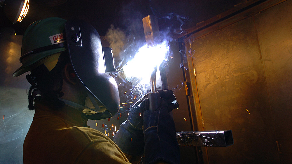 Student welding in the shop