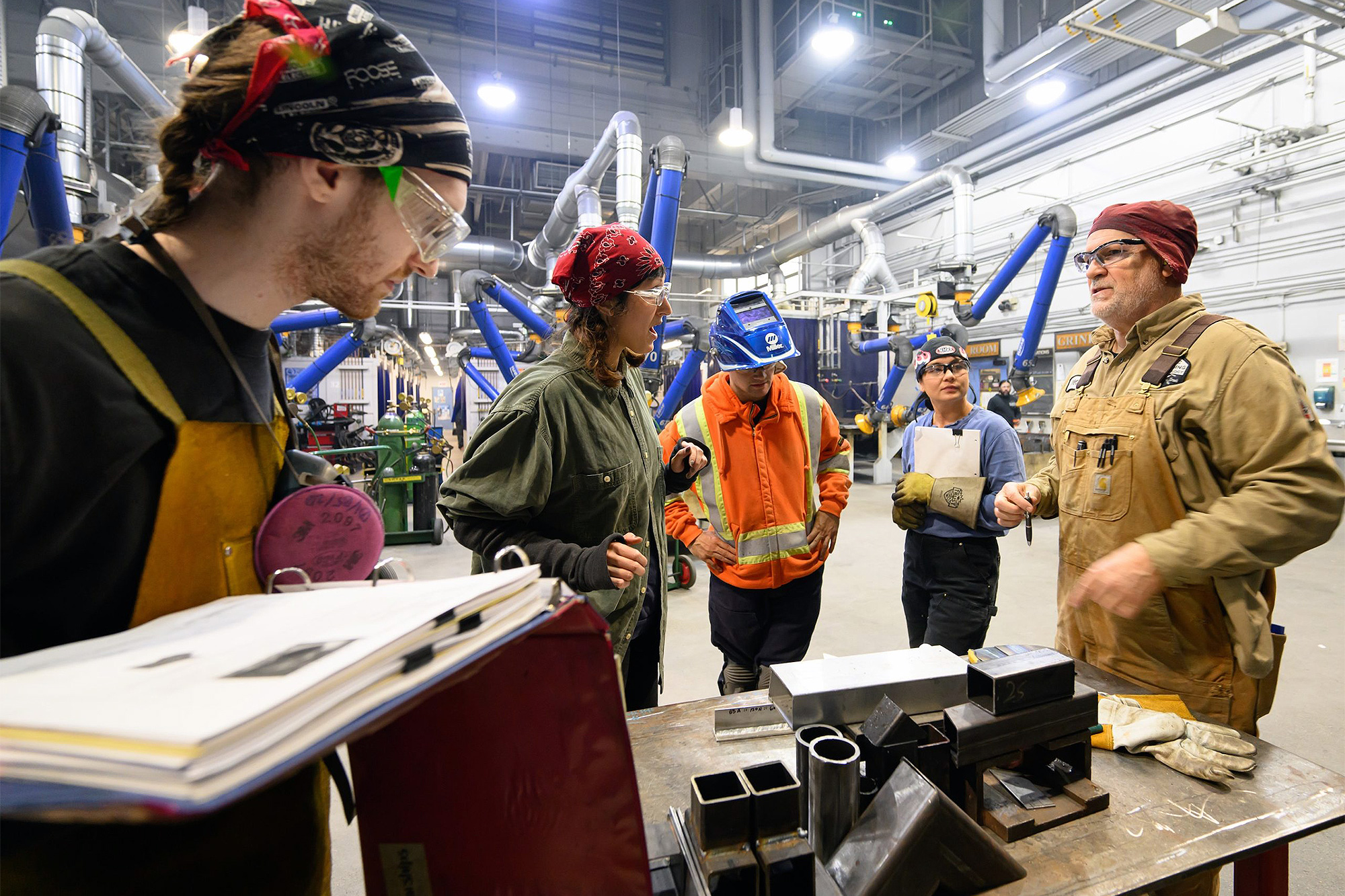 Welding students in class with their instructor