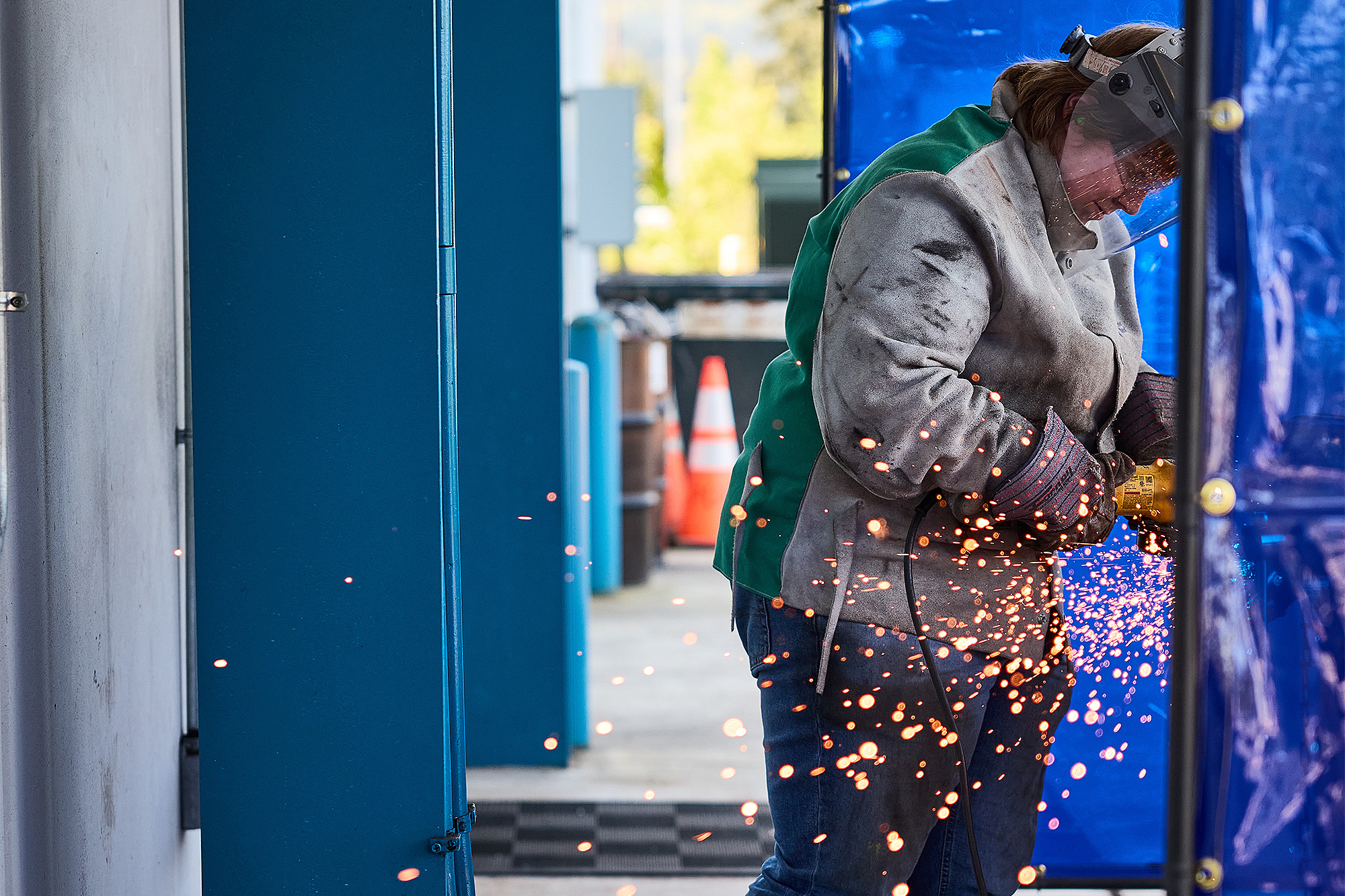 Welding student grinding their work