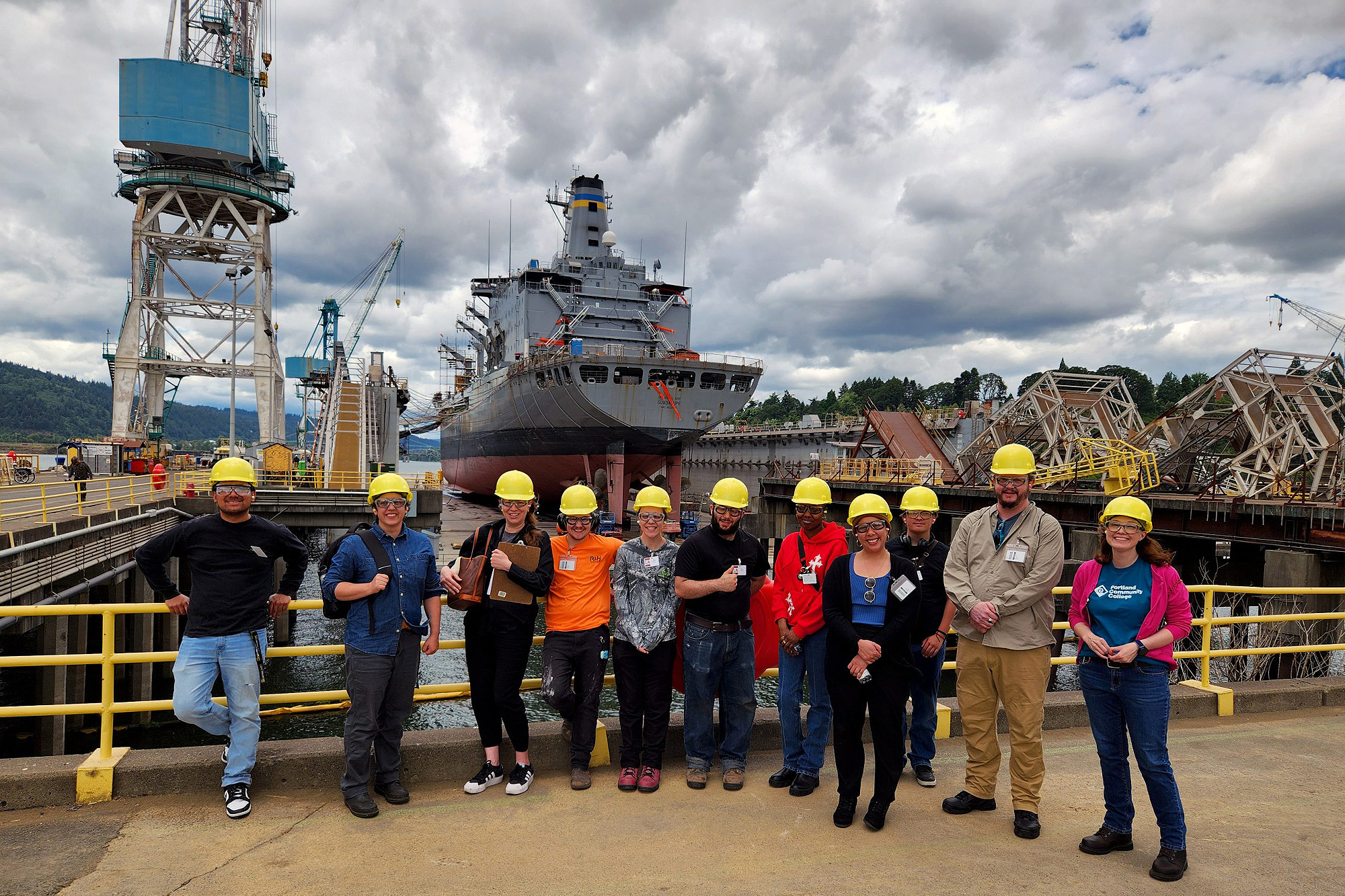 Maritime welding students in front of a ship at Swan Island
