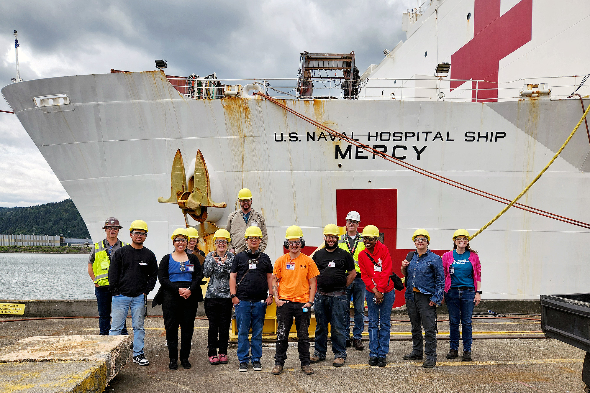 Maritime welding students in front of a ship at Swan Island
