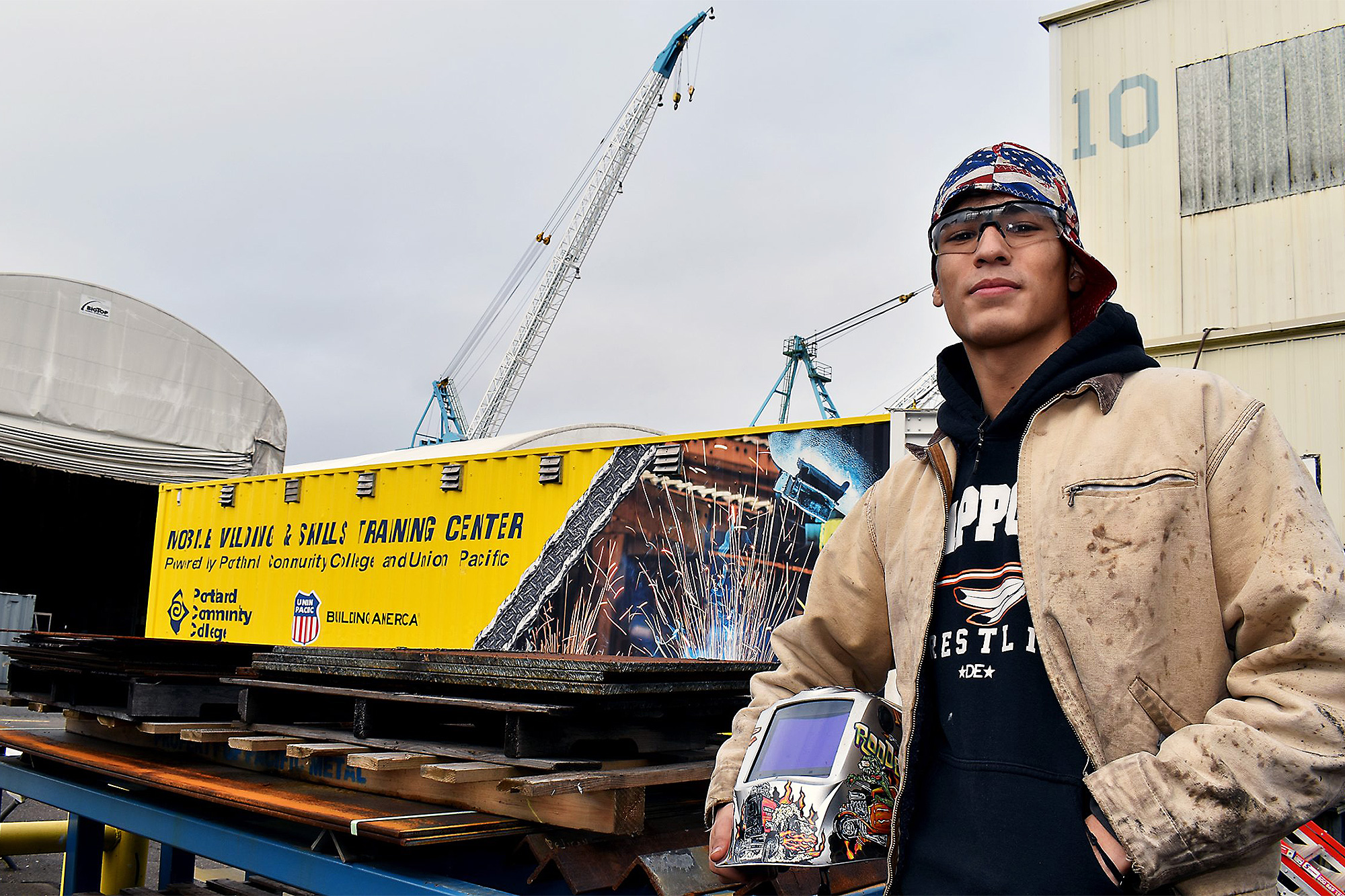 Maritime welding student in front of the mobile welding center truck