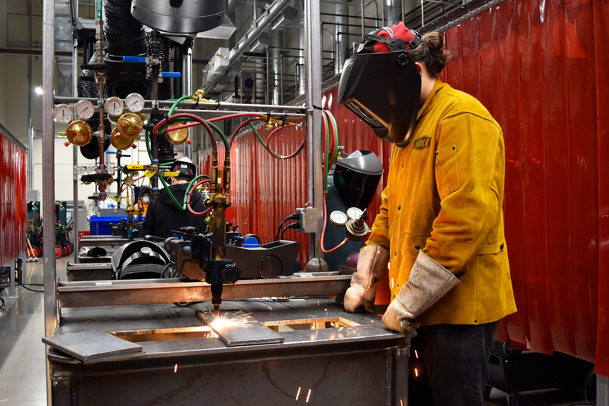 Student at a gas tungsten arc welding table in the shop