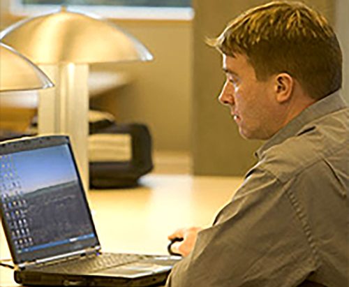 Training and Certification student in front of a computer