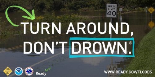 The words 'turn around don't drown' over an image of a flooded road