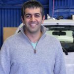 Farhad Ghafarzade owner of Green Drop Garage and graduate of Advanced Small Business Management stands in first Green Drop Garage location.