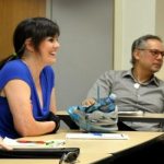 Man and woman sit at table in PCC CLIMB classroom