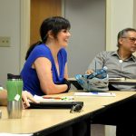 Man and woman sit at table in PCC CLIMB classroom