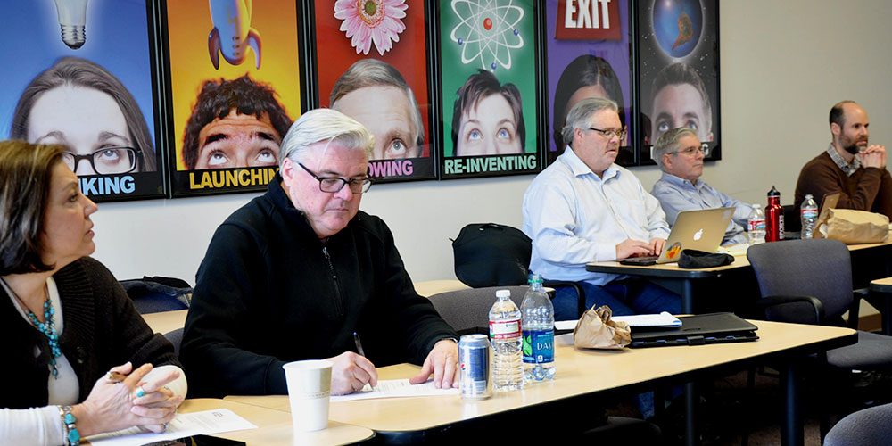 Man in green shirt takes practice test at PCC CLIMB