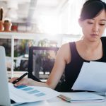 Businesswoman doing paperwork at her workplace