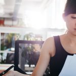 Businesswoman doing paperwork at her workplace