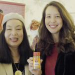 Two GYRM alumni holding their sauce bottles