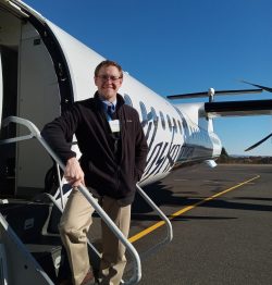 Anders standing on external stairs at forward end of Q400