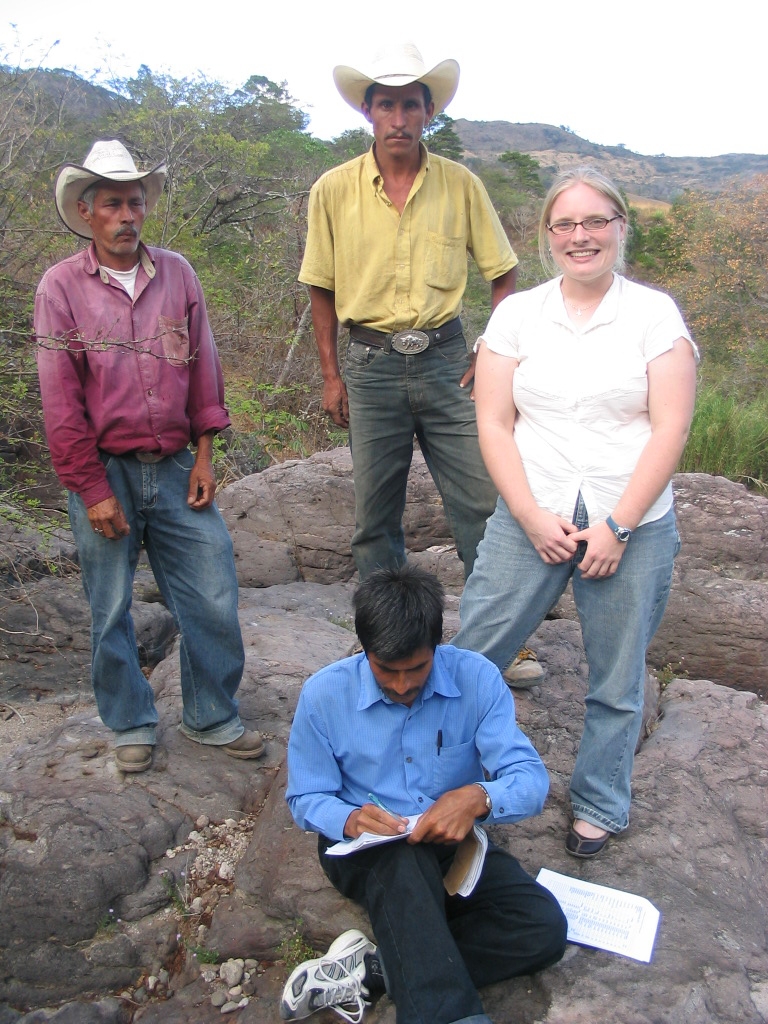 Annie Crater working as a Peace Corps volunteer with three local stakeholders in El Caracol, Honduras.