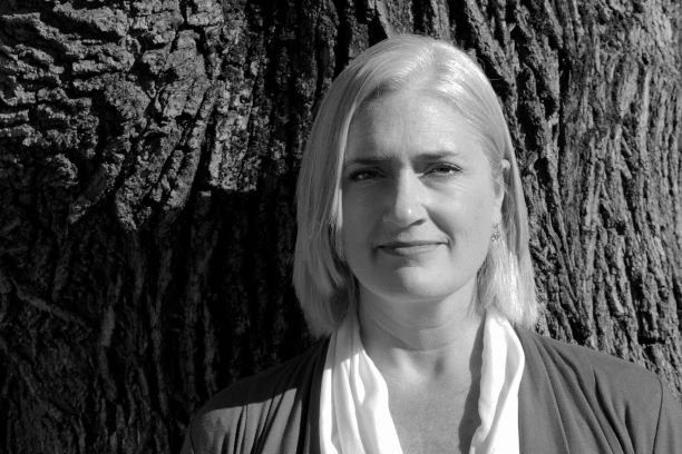Image of Jennifer Bird, in front of a tree. Photo credit: Jessica Johnson